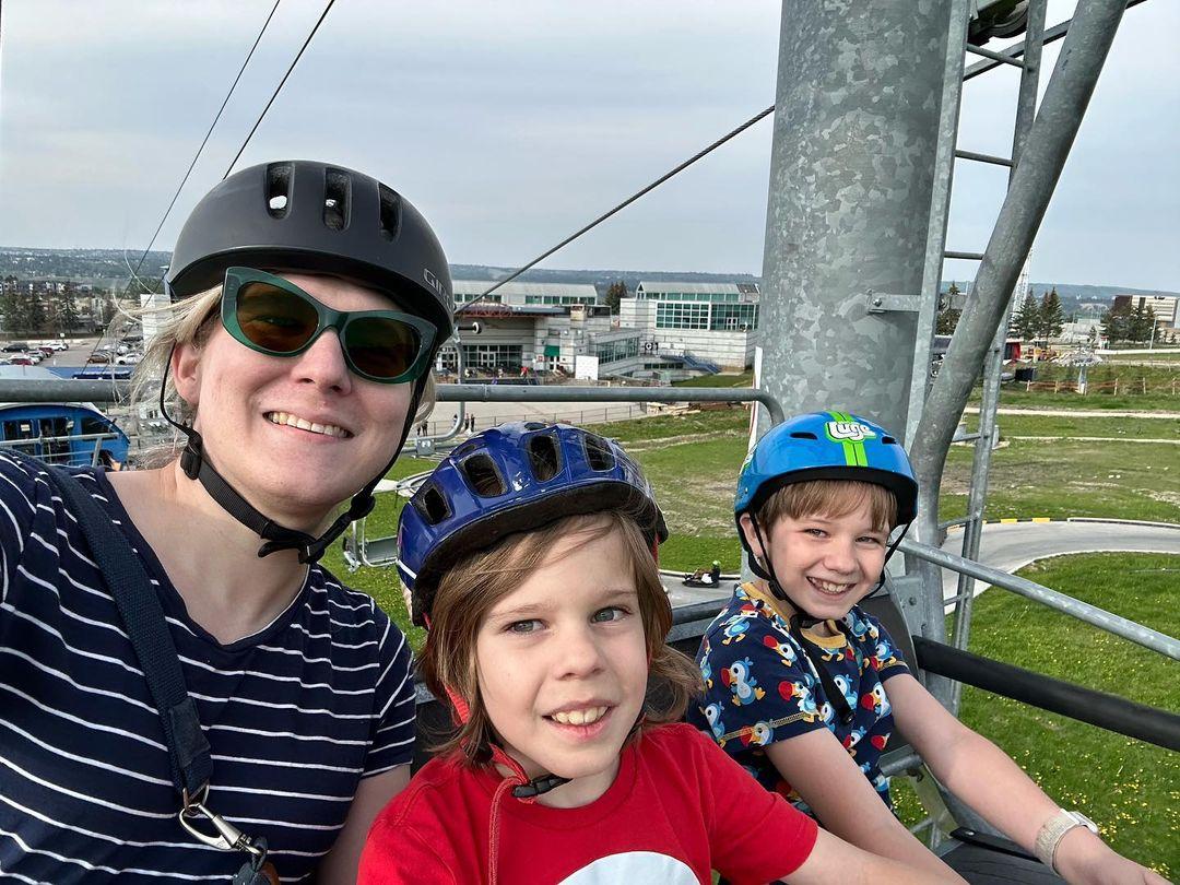 A family rides the Downhill Karting Calgary chairlift together.